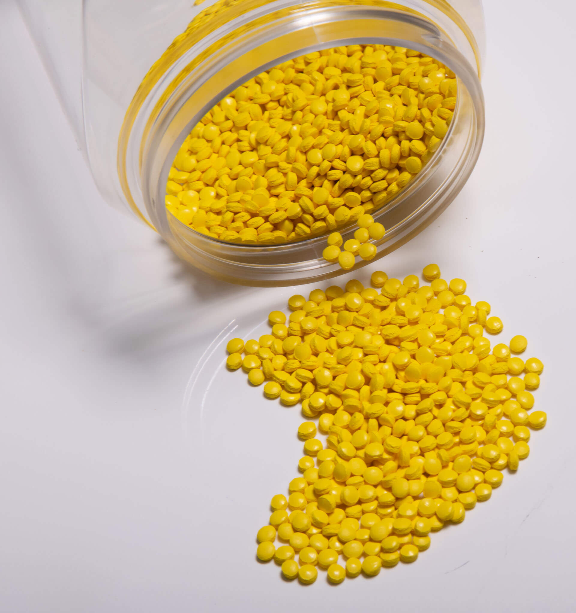 pile of injection molding resin pellets that is yellow